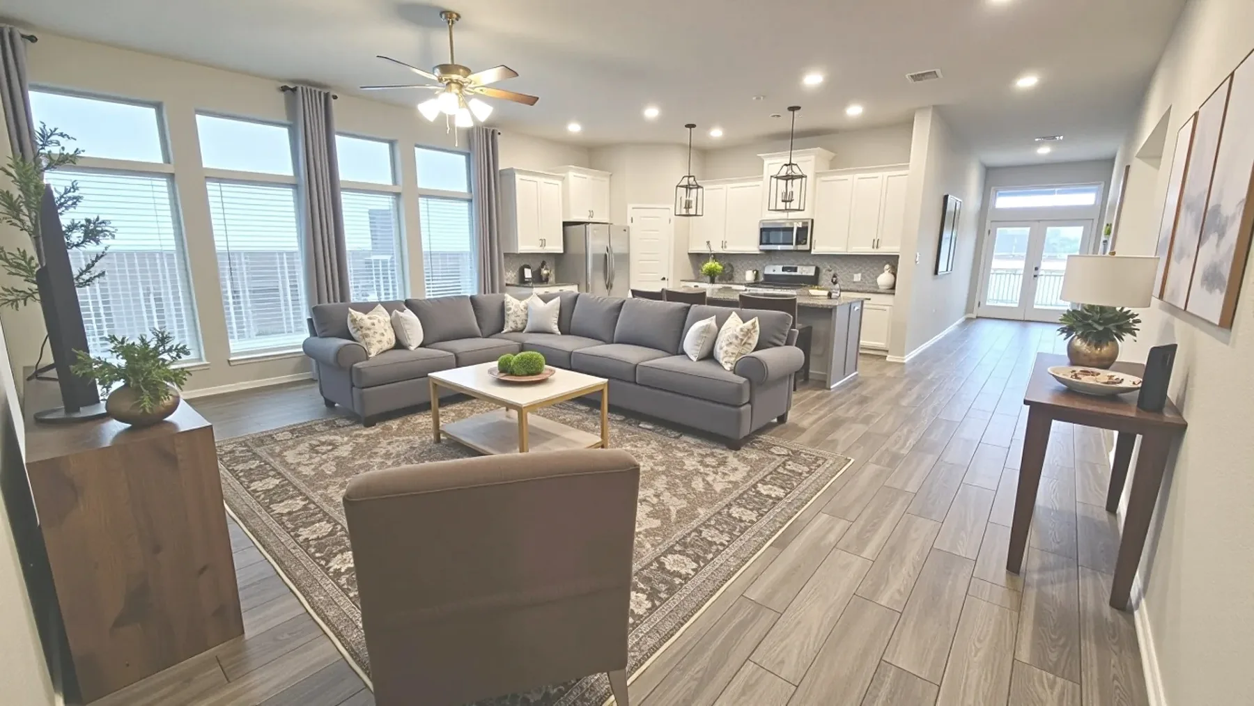 Bright furnished living room and open kitchen at the Aggie Run home