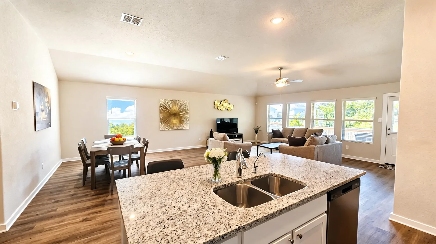 Open furnished kitchen, dining, and living area at the Beebrush Saddle home