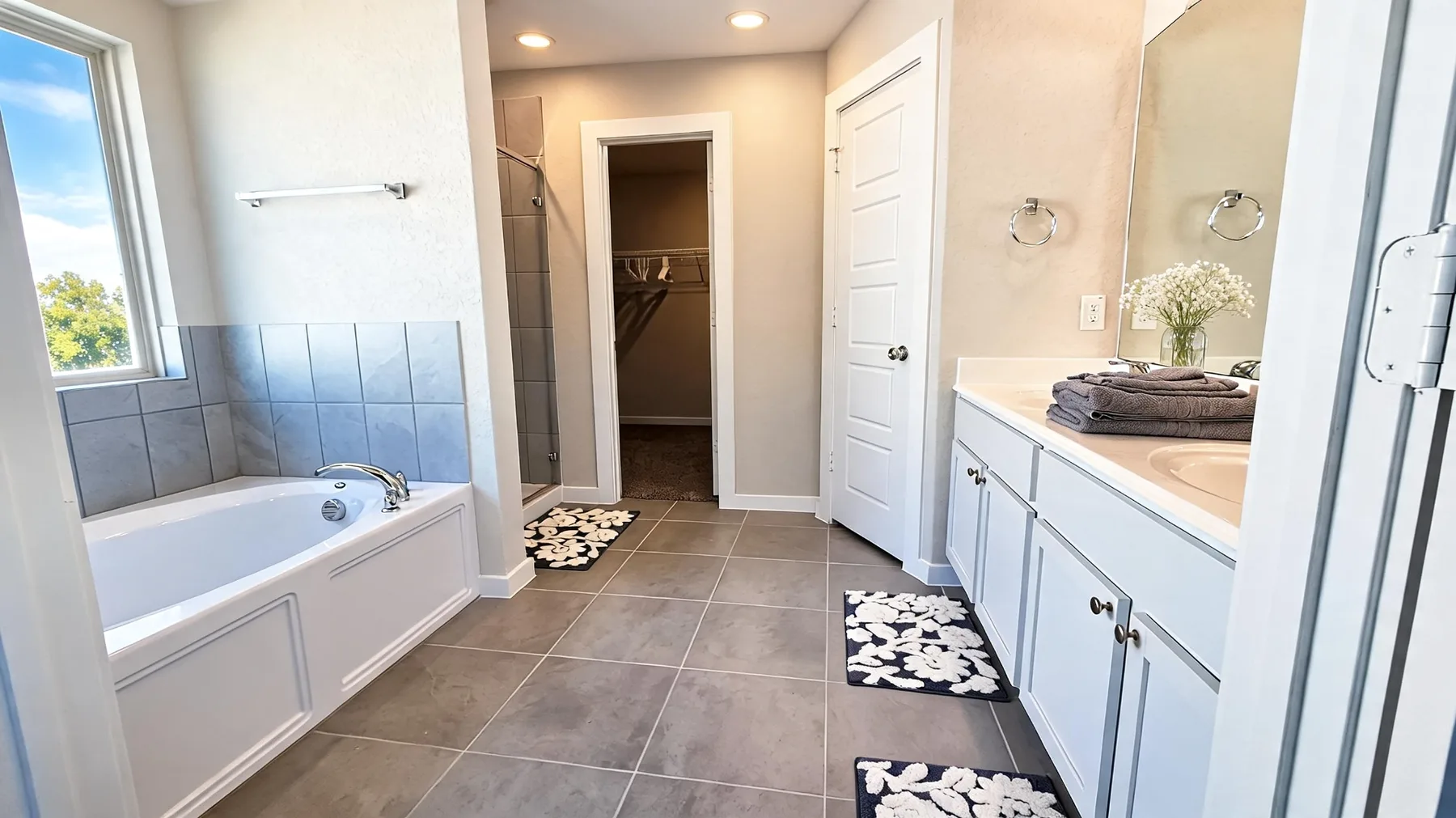 Primary bathroom with double vanity, soaking tub, and shower at Beebrush Saddle