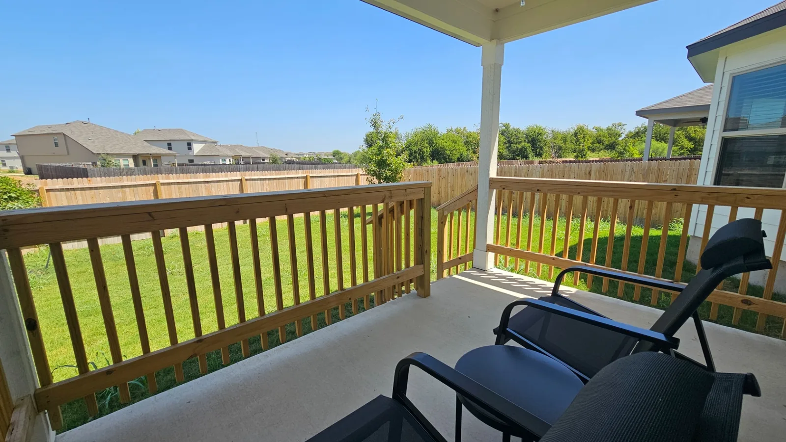 Covered backyard patio with seating at the Beebrush Saddle home