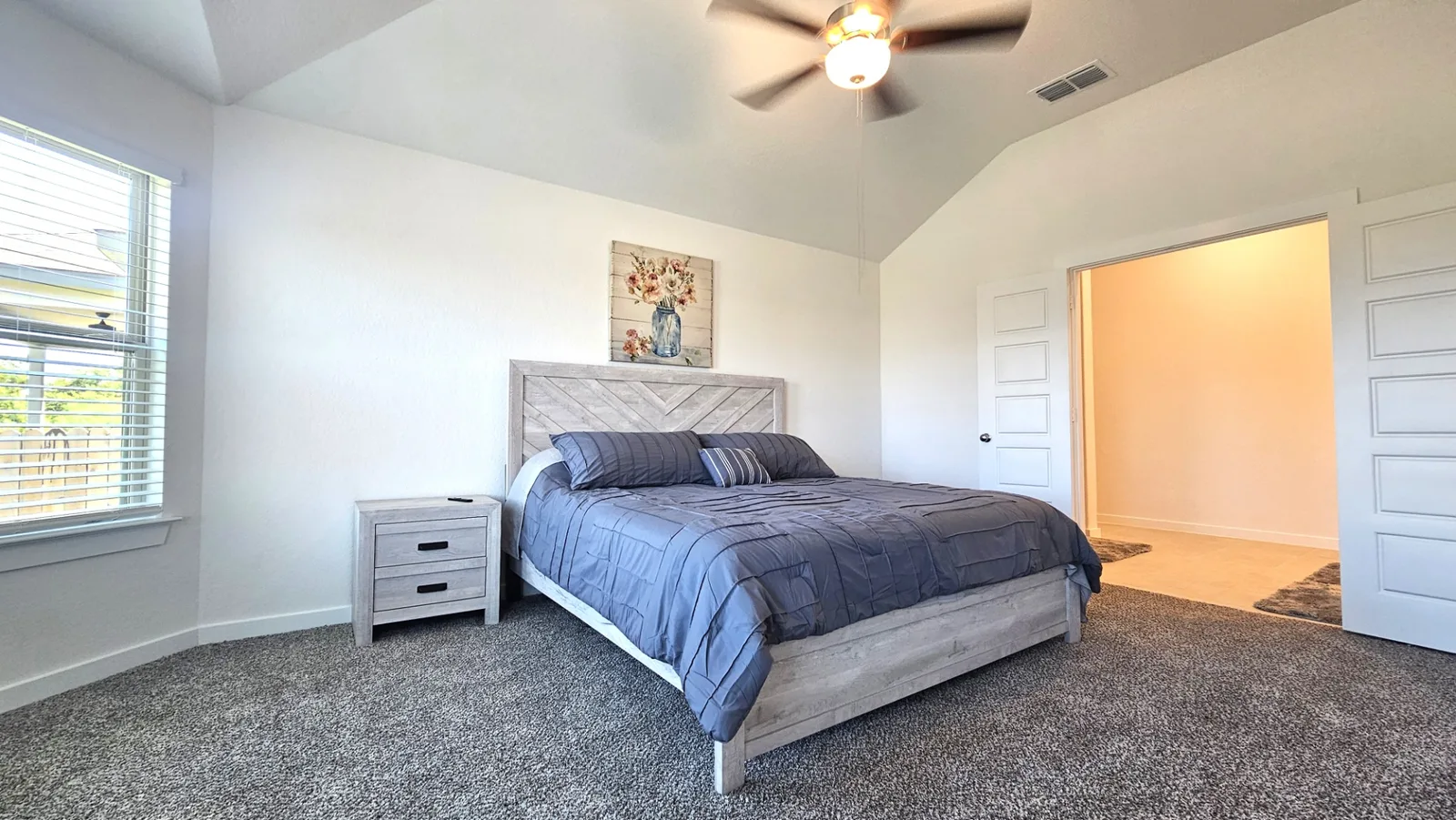 Bright furnished primary bedroom with high ceiling at Beebrush Saddle
