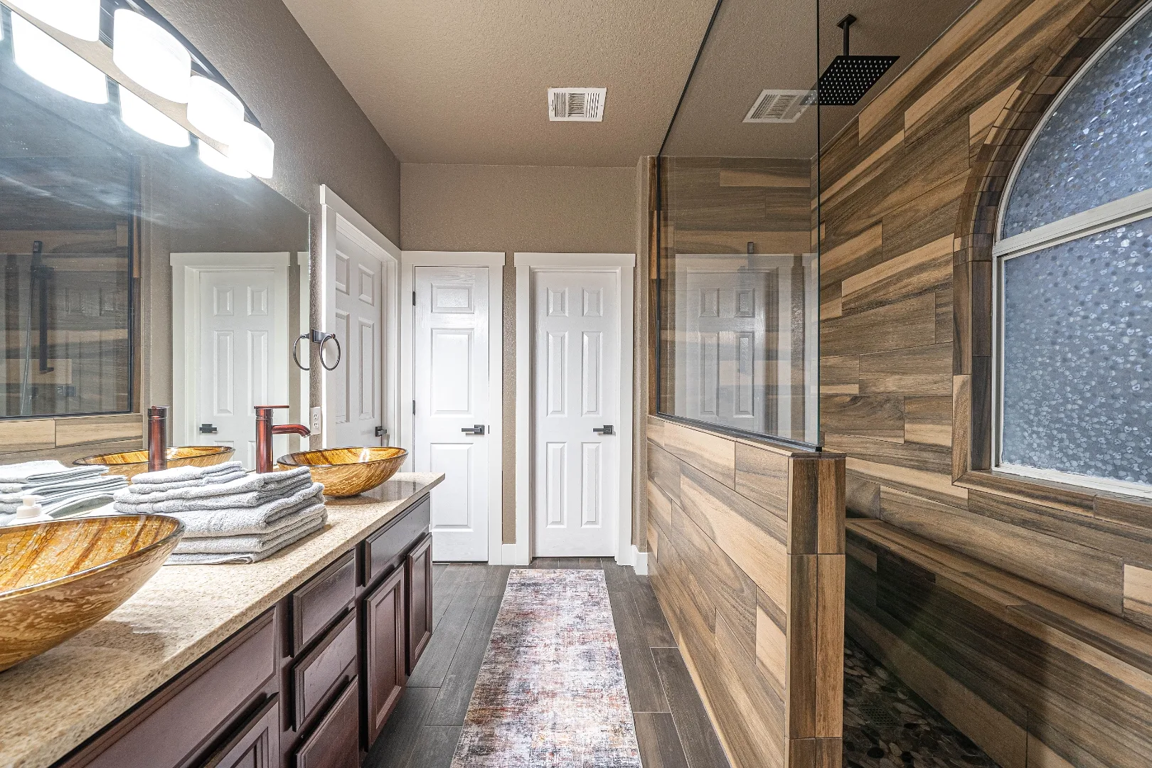 Primary bathroom with double vanity and walk-in shower at Bright Chase